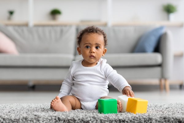 developmental-toys-concept-cute-little-black-infant-boy-playing-with-building-blocks-scaled-1